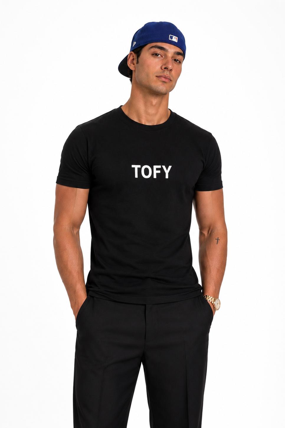 A man modeling a black short-sleeve crewneck t-shirt with the word 'TOFY' printed in white across the chest, paired with black pants and a blue baseball cap, against a plain white background.